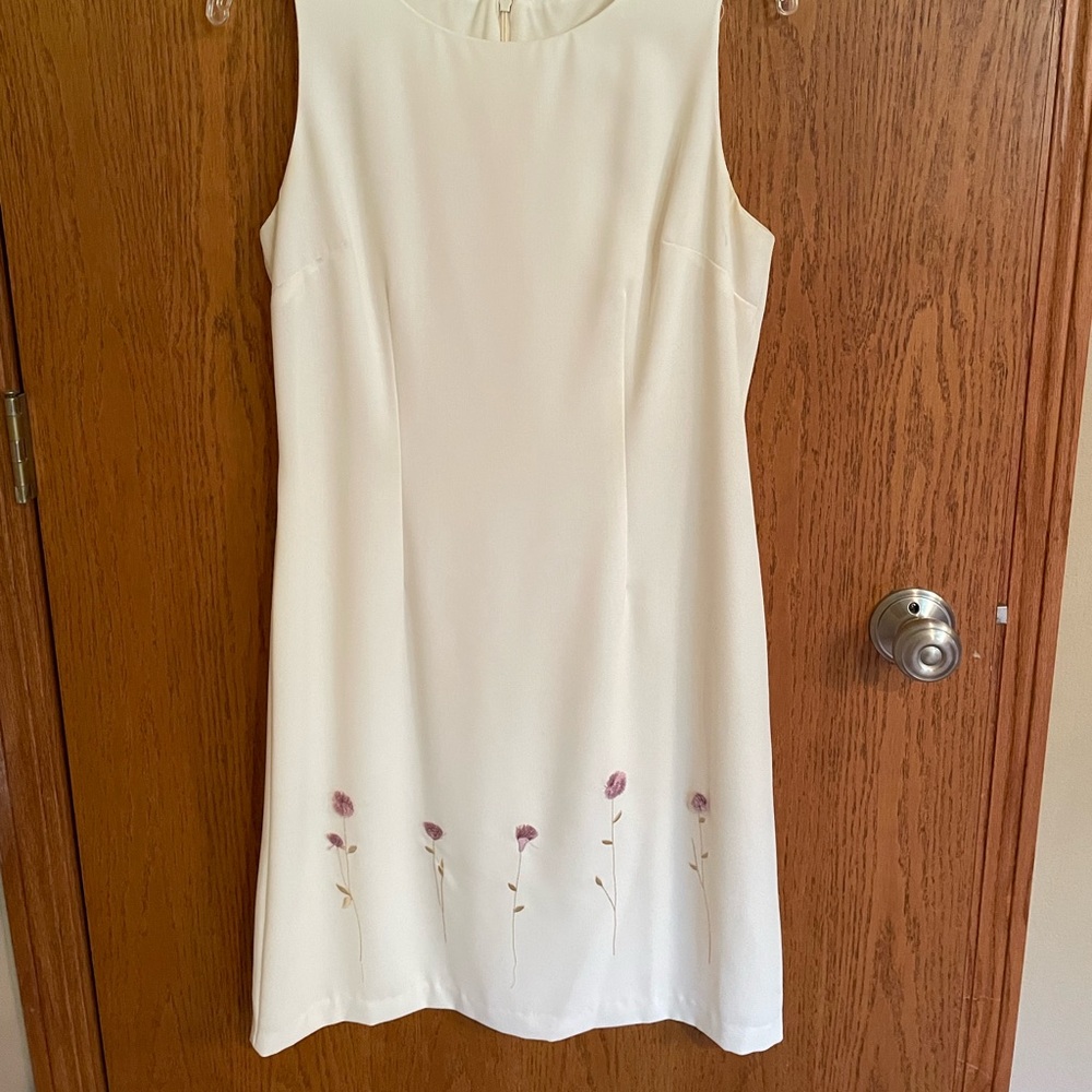 Stunning white / cream dress with embroidery flower details at hem.